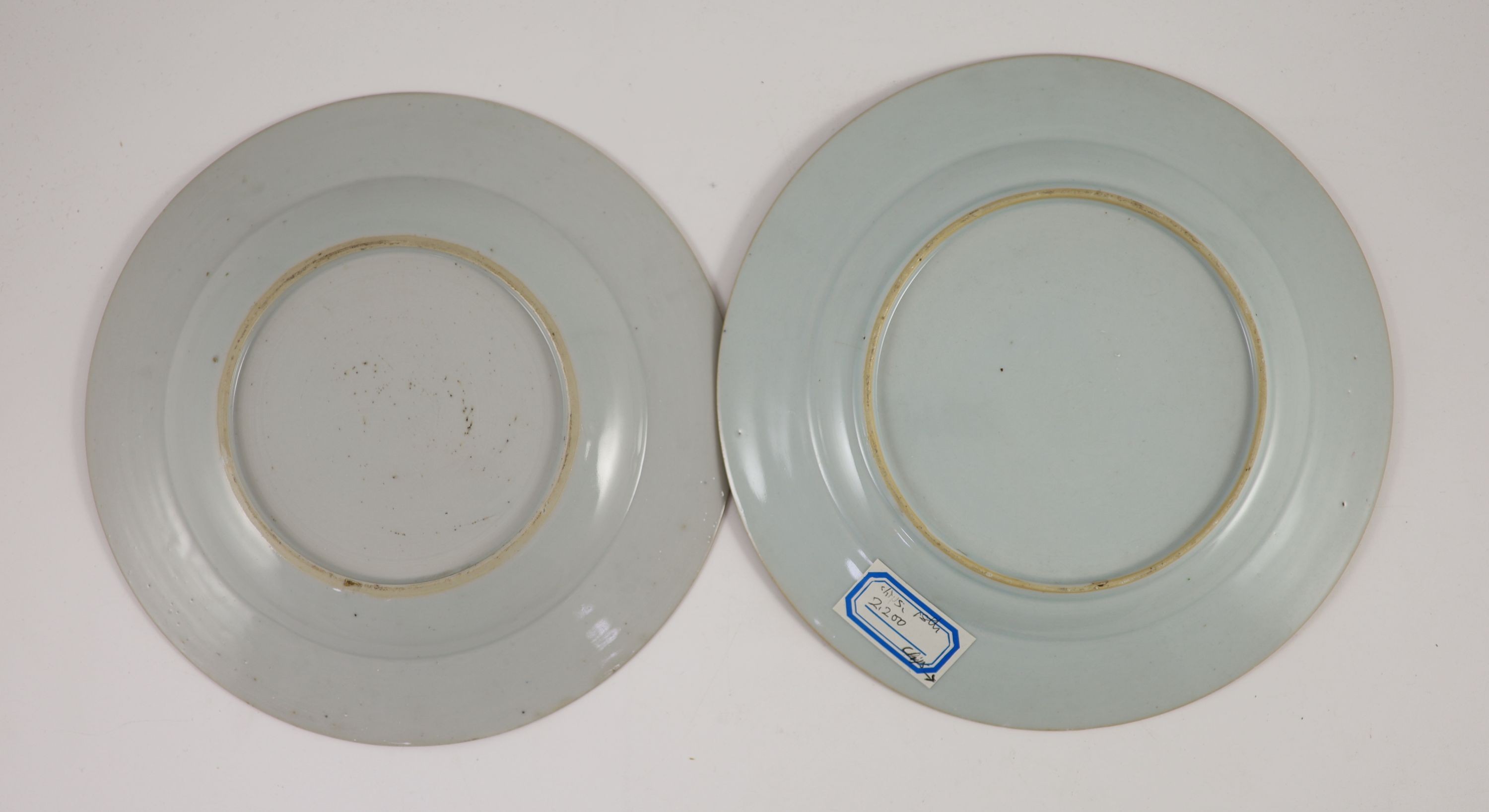 A near pair of Chinese famille rose plates, early Qianlong period, 23.3 and 22.7cm diameter